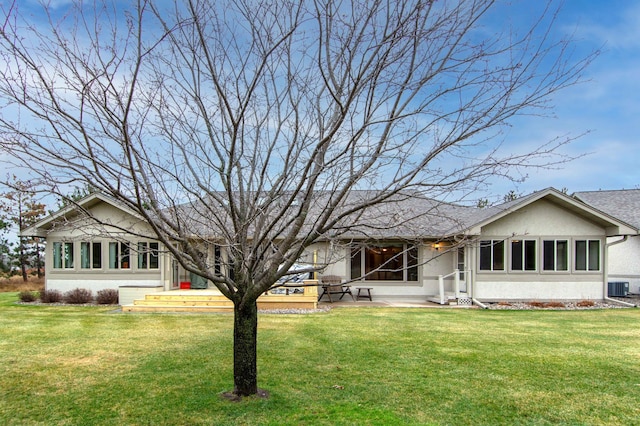 back of house with a lawn and central AC