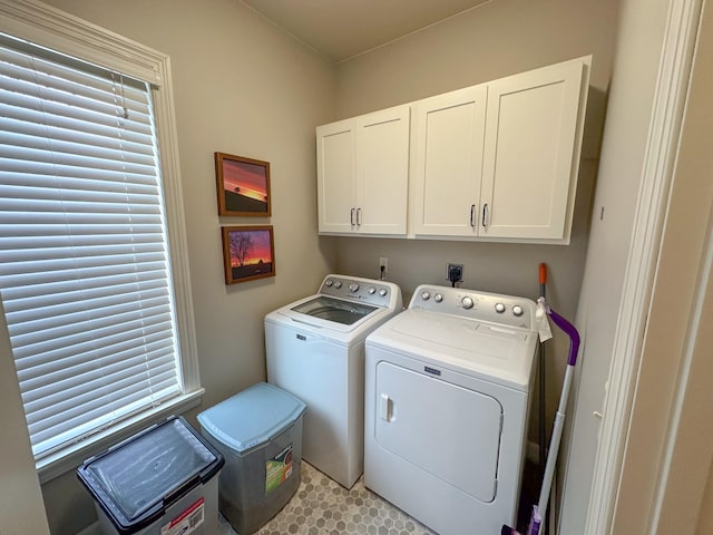 washroom featuring washer and clothes dryer and cabinets