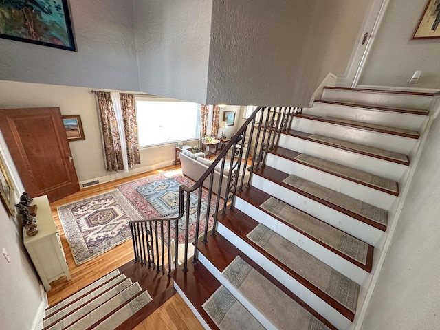 stairs with hardwood / wood-style flooring