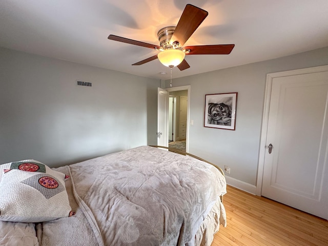 bedroom with ceiling fan and light hardwood / wood-style floors