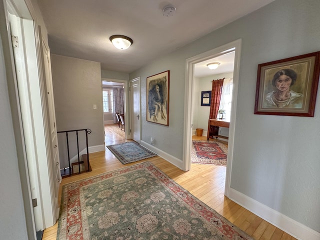 foyer entrance with light wood finished floors and baseboards