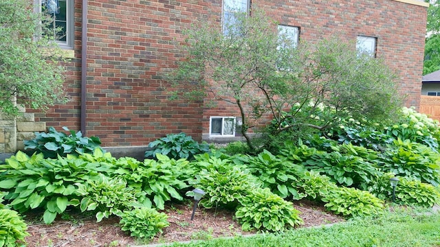 view of side of home with brick siding