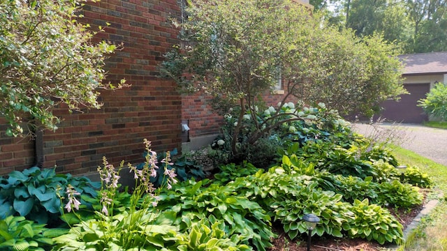 view of side of property featuring brick siding and an attached garage