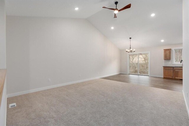S1546 Shawnee Dr Unit B, Alma, WI 54610 - unfurnished living room featuring carpet floors, a chandelier, vaulted ceiling, recessed lighting, and baseboards