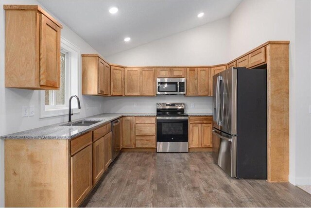 S1546 Shawnee Dr Unit B, Alma, WI 54610 - kitchen with appliances with stainless steel finishes, a sink, dark wood-type flooring, light stone counters, and recessed lighting