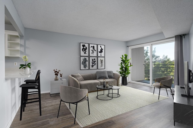 living room with hardwood / wood-style floors and a textured ceiling