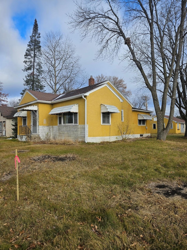 view of home's exterior with a yard