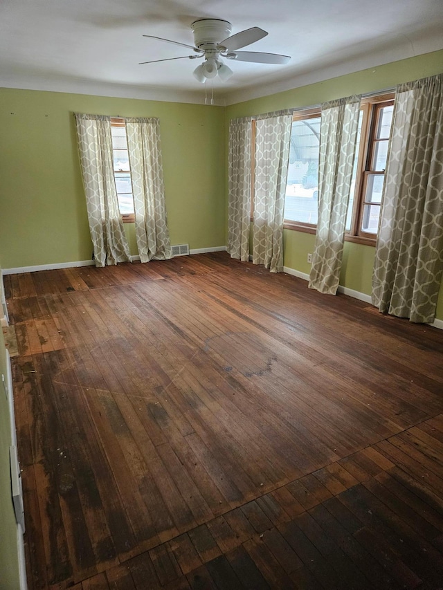 unfurnished room with ceiling fan and dark wood-type flooring