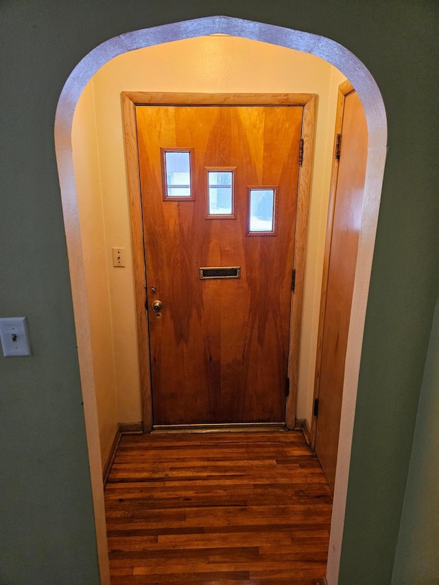 doorway to outside featuring dark wood-type flooring