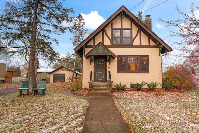 tudor-style house with an outdoor structure