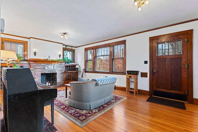 living room featuring ornamental molding, a healthy amount of sunlight, and light wood-type flooring