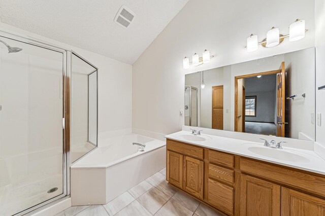 full bathroom featuring visible vents, a stall shower, a garden tub, and a sink