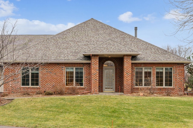 ranch-style home featuring brick siding, a front lawn, and a shingled roof