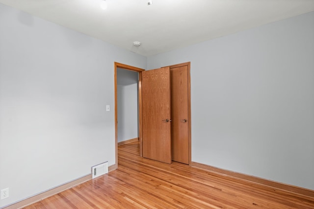 unfurnished room with light wood-type flooring