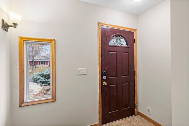 foyer with a textured ceiling