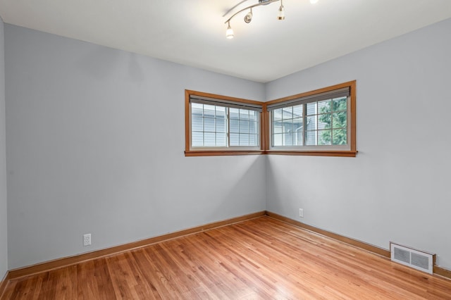 unfurnished room with light wood-type flooring