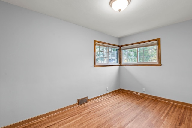 spare room featuring light wood-type flooring