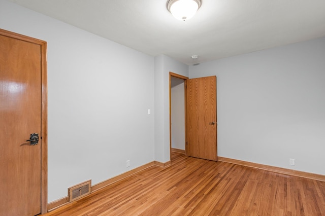 spare room with hardwood / wood-style floors