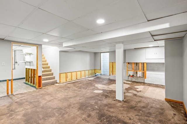 basement with a paneled ceiling