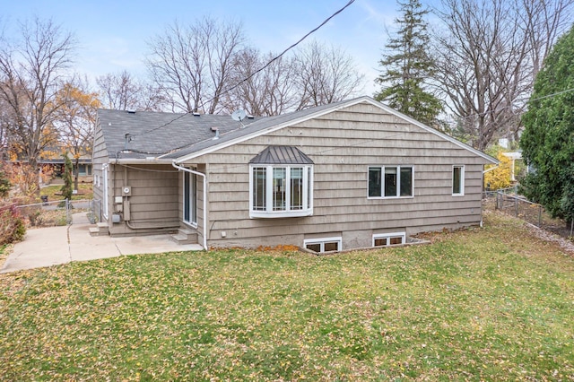 rear view of house with a patio area and a yard