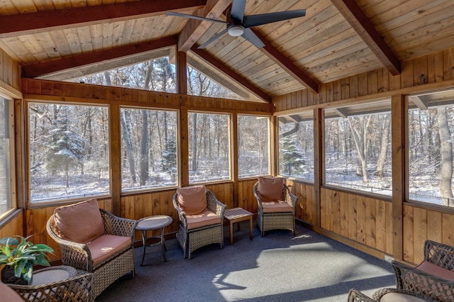 sunroom / solarium with wooden ceiling, lofted ceiling with beams, and a ceiling fan