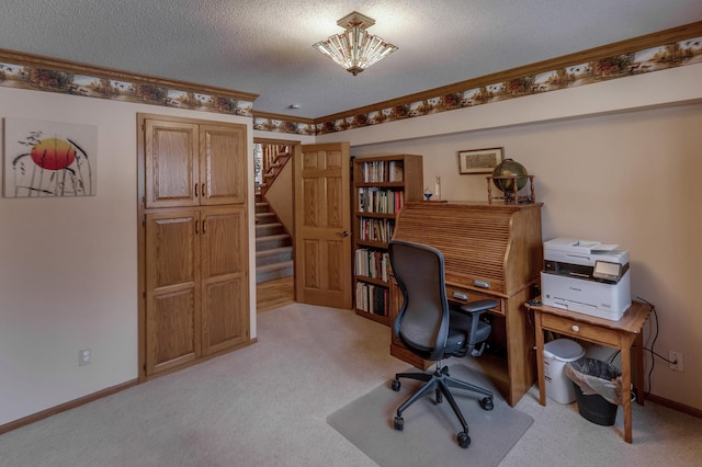 office with ornamental molding, light colored carpet, baseboards, and a textured ceiling