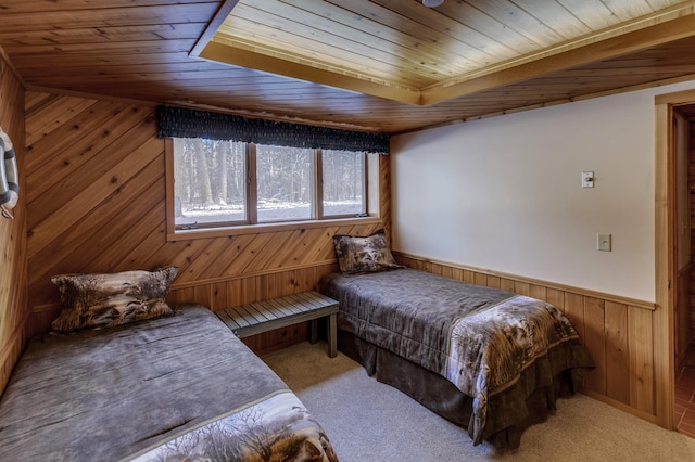 carpeted bedroom with wooden ceiling, wood walls, and wainscoting