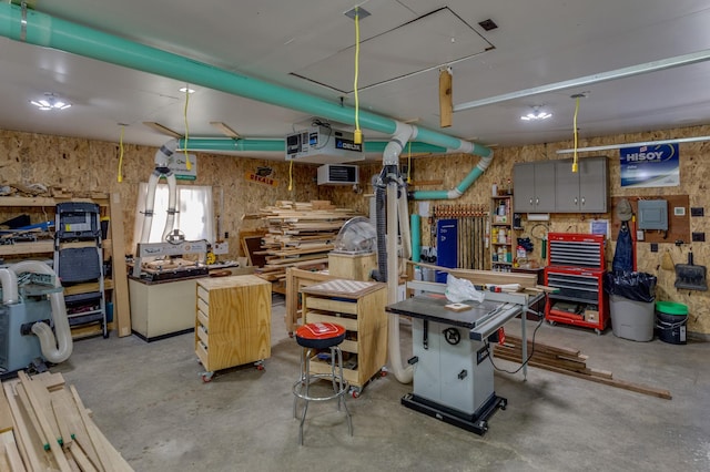 misc room with a workshop area and concrete flooring