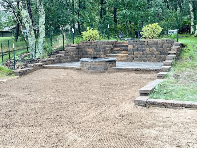 view of yard with a fire pit