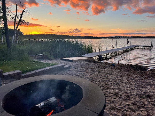 view of dock featuring a hot tub and a water view