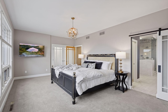 carpeted bedroom with a barn door and an inviting chandelier