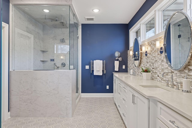 bathroom with vanity, walk in shower, and backsplash