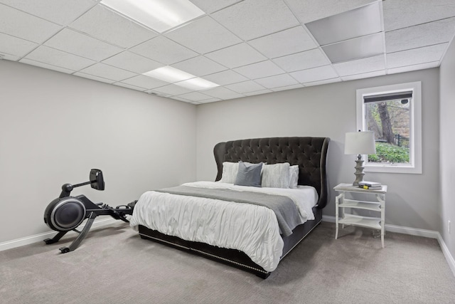 carpeted bedroom with a paneled ceiling