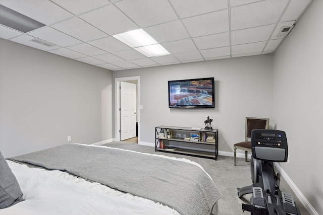 bedroom featuring a paneled ceiling and carpet floors