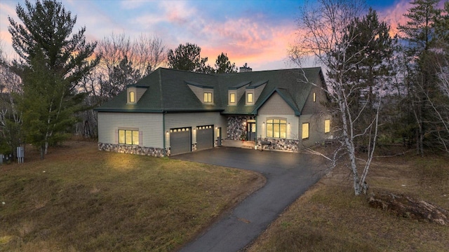 view of front facade featuring a lawn and a garage