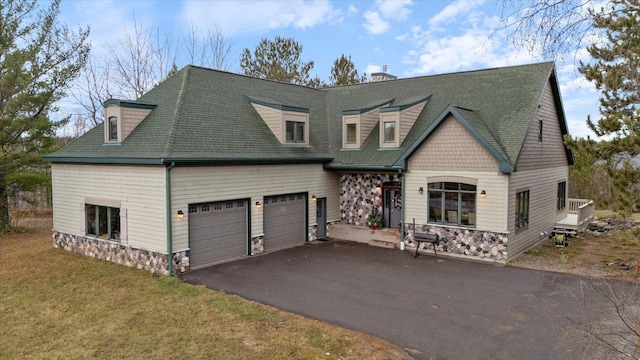 view of front of house with a front yard and a garage