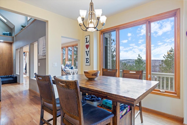 dining room featuring a notable chandelier and light wood-type flooring