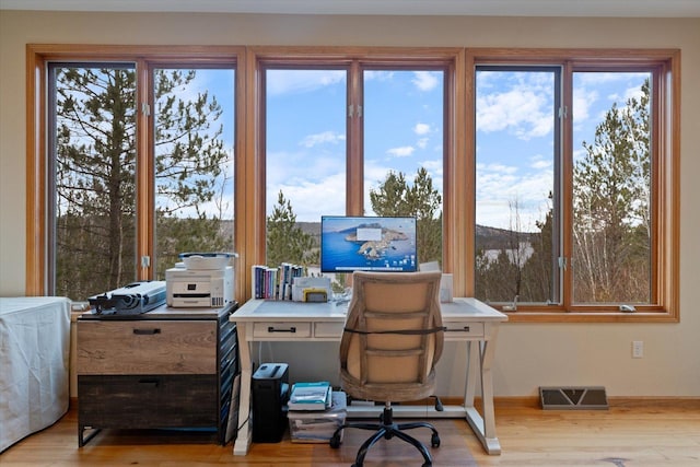 office space with light wood-type flooring