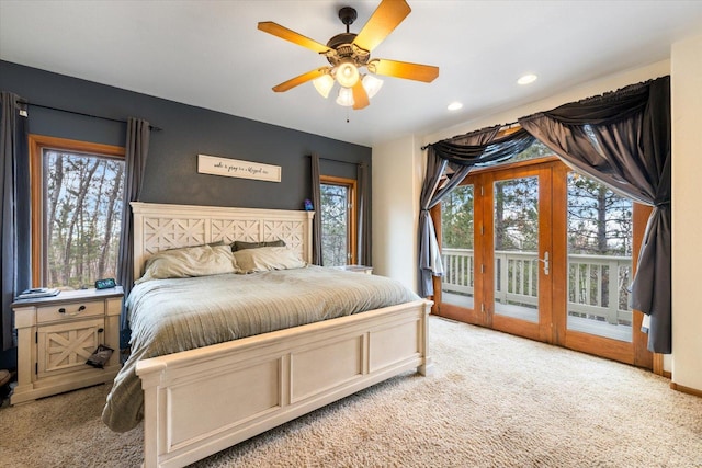 bedroom with ceiling fan, light colored carpet, access to outside, and french doors