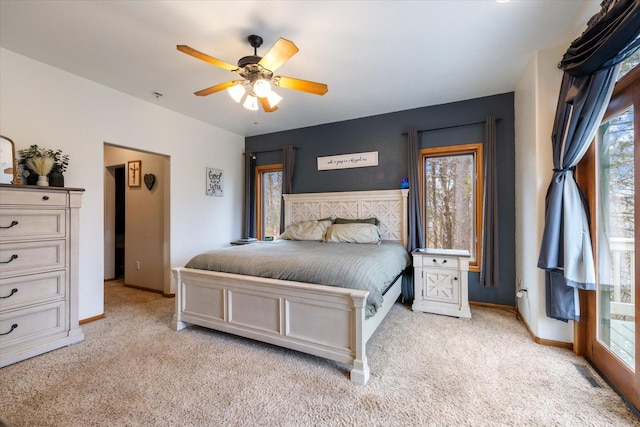 carpeted bedroom with access to outside, multiple windows, and ceiling fan