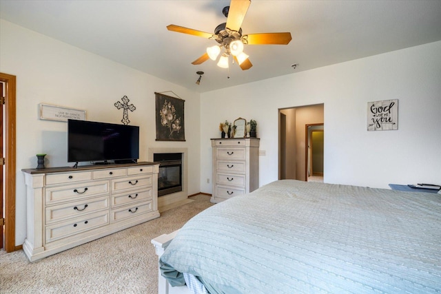 bedroom featuring light colored carpet and ceiling fan