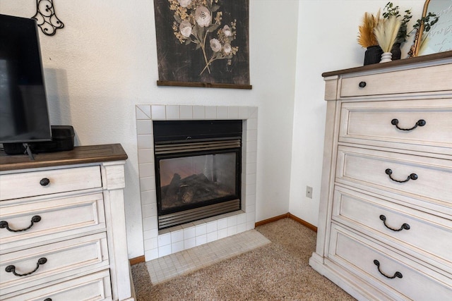 details featuring carpet flooring and a tiled fireplace