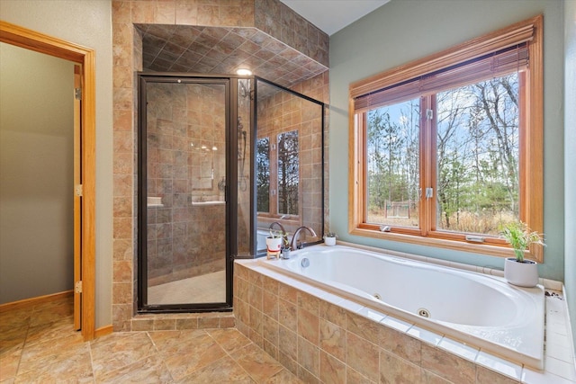 bathroom with plenty of natural light and shower with separate bathtub