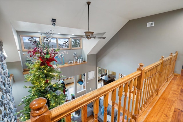 interior space with ceiling fan, vaulted ceiling, and hardwood / wood-style flooring