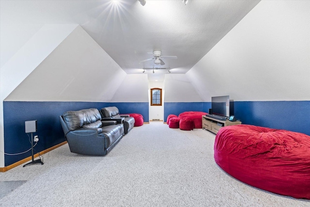 living room featuring carpet flooring, ceiling fan, lofted ceiling, and a textured ceiling