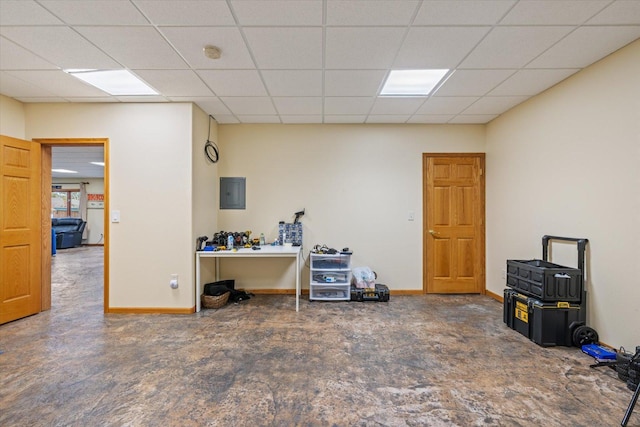 interior space with a drop ceiling and electric panel