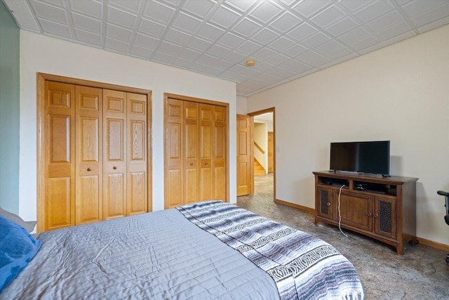 carpeted bedroom featuring multiple closets