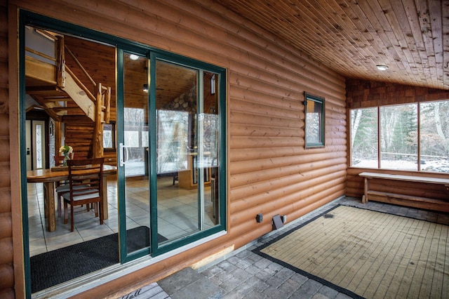 unfurnished sunroom with wooden ceiling and vaulted ceiling