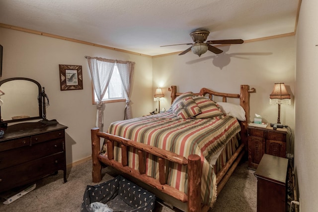 carpeted bedroom with a textured ceiling, ceiling fan, and crown molding