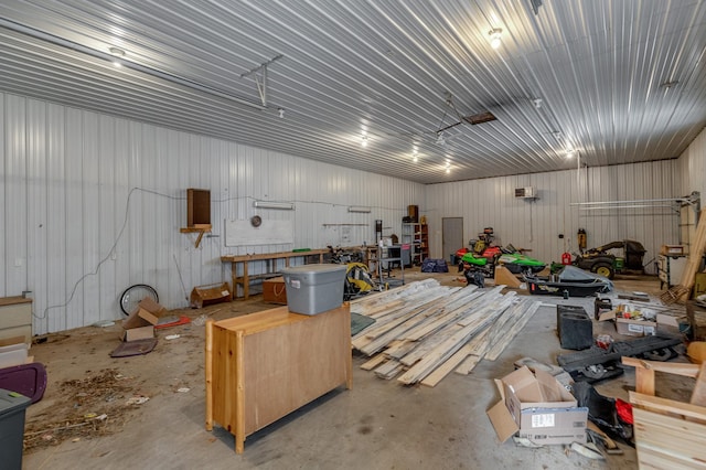 garage featuring metal wall and a workshop area